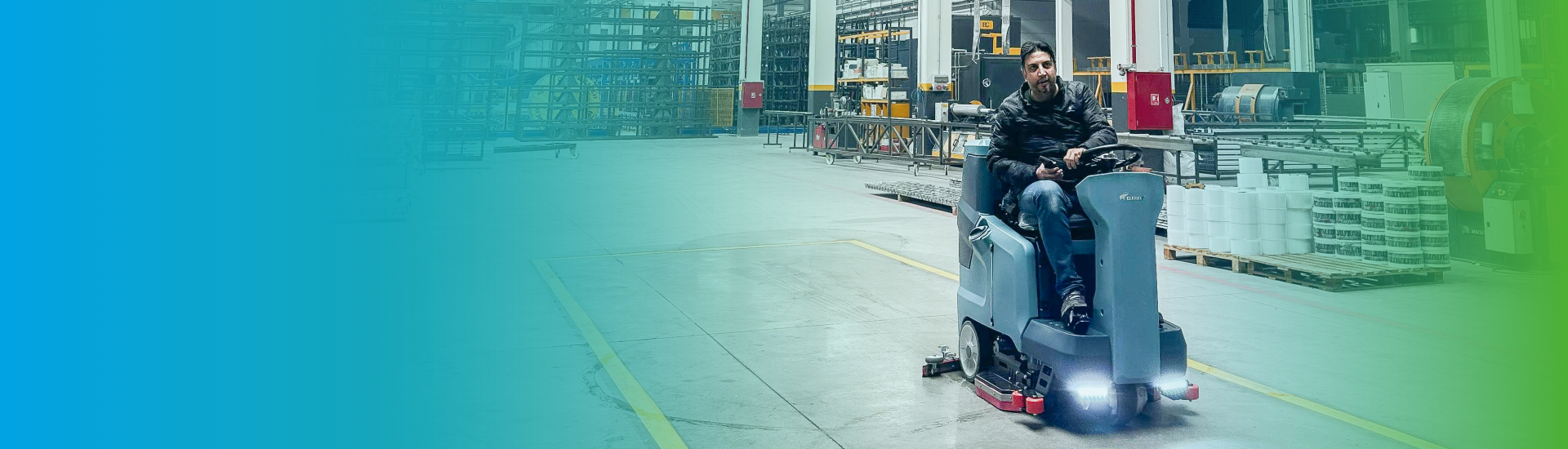 Industrial floor-cleaning equipment operating in a factory environment